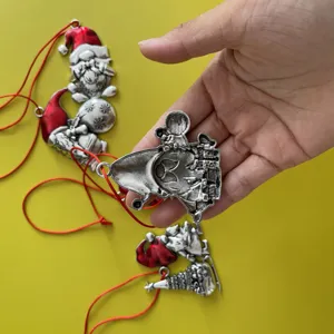 Christmas tree metal gnome ornament with red hanging string, perfect for holiday decor.