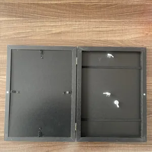 Kids art frame storage box with black wooden finish and elastic bands for display.