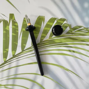 Silicone liquid eyeliner brush detail view, black handle with white precision tip tool.