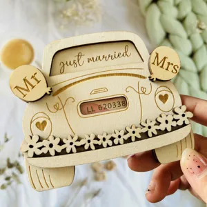 Wooden wedding car money clip detail view, featuring laser engraved text and floral decoration.