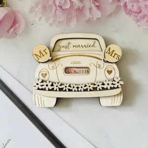 Close-up detail of wooden wedding car money clip, laser engraved design with floral and text.