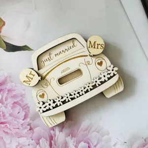 Wooden wedding car money holder close up, engraved just married design with floral details.
