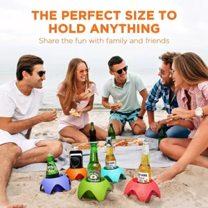 Colorful plastic beach cup holders in sand, outdoor drink and phone stand for picnic party.