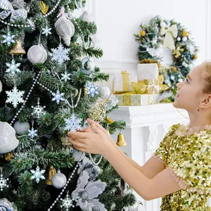 Detailed scene of blue snowflake ornaments decorating a festive Christmas tree with bright lights.