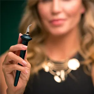 Professional silicone eyeliner brush for precise eye makeup application, sleek dark green handle.