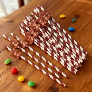 Close-up detail of cute brown and white striped paper straws with adorable bear decorations.
