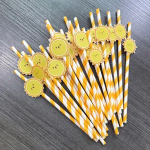 Closeup detail of cute smiling sun paper straws with yellow stripes for party decor.