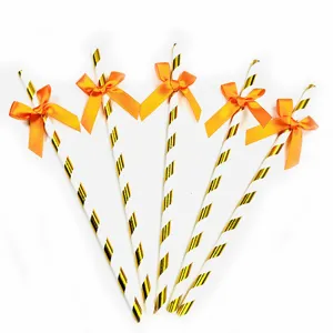 Decorative paper straws with orange bows, ideal for party dessert tables and birthdays.