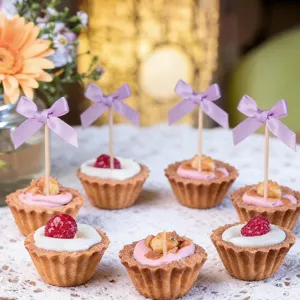 Detail view of 10pcs purple bow cake toppers, perfect for party baking and dessert decorations.