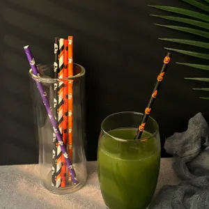 Biodegradable disposable paper straws featuring spooky Halloween pumpkin and skull party designs.