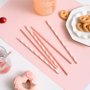 Pink paper straws detail shot, biodegradable disposable drinking straws for party decor.