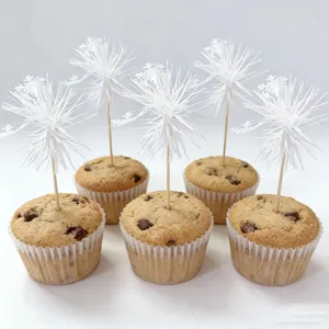 White snowflake cupcake toppers detail shot for holiday dessert decoration and party baking.