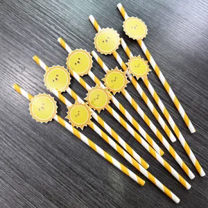 Close-up detail of yellow-white striped paper straws featuring cute smiling sun party decors.