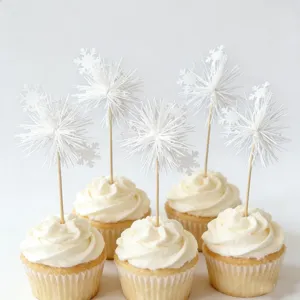 White snowflake cupcake toppers and tassel picks, perfect for winter and holiday desserts.