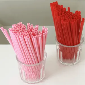 Heart-shaped plastic drinking straws, pink and red party straws for romantic events.