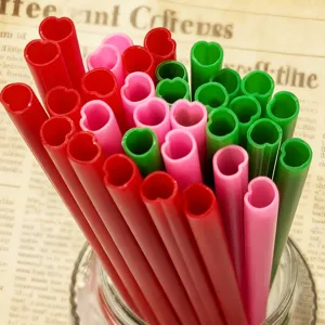 Colorful PP plastic heart-shaped drinking straws detail view, creative cute design for parties.