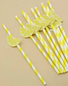 Disposable biodegradable paper straws with cute lemon slice decorations for party drinks.