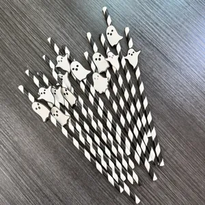 Detailed shot of Halloween paper drinking straws featuring cute white ghost decorations.