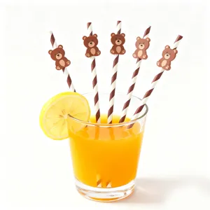 Creative party paper straws with cute bear decorations inserted in a juice glass.