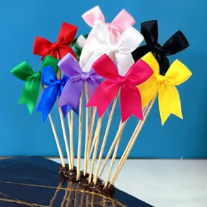 Colorful ribbon bow cake toppers set, 2.5cm handmade bows with wooden sticks for party decor.