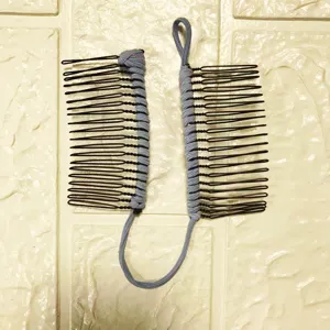 Closeup of blue-grey elastic banana hair clip dual comb detail showing flexible stretch cord.