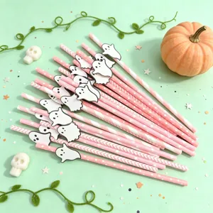 Detailed view of Halloween pink paper straws with cute ghost cutouts for party table decor.