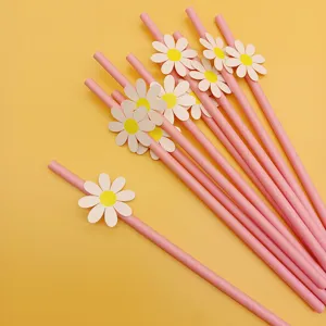 Pink paper straws with cute white daisy card decorations, perfect for birthday party supplies.