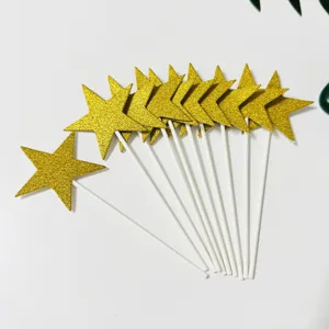Detailed view of gold glitter star cake toppers with white sticks, perfect for party desserts.
