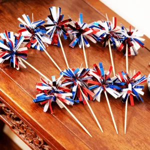 Close-up of red white and blue foil fringe firework picks for party dessert cake decoration.
