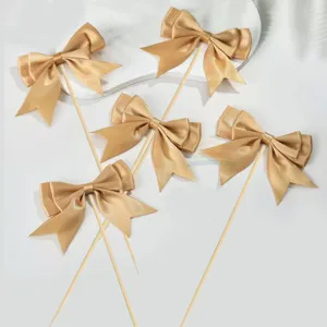 Gold satin ribbon bow cake toppers set, elegant dessert decorations for birthday party and wedding.