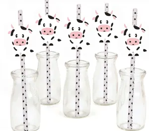 Cute cow paper straws set with clear glass bottles for party decoration and beverage display.