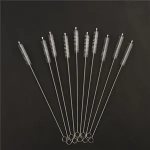 Close-up detail of stainless steel straw cleaning brushes, featuring durable bristles.