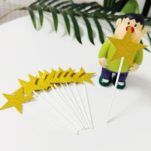Gold glitter star cake topper detail view, perfect for birthday party and dessert decoration.