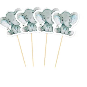 Close-up of cute watercolor baby elephant cupcake toppers with wooden picks for party decor.
