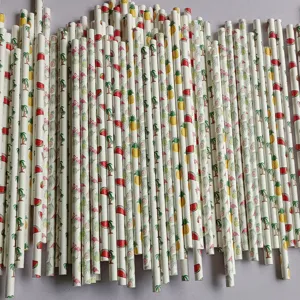 Close-up detail of tropical summer themed paper straws with flamingo and pineapple prints.