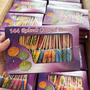Detailed view of colorful cocktail parasols paper umbrellas in 144 box packaging setup.