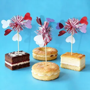 Close-up of colorful firework heart cake toppers for Valentine day dessert decoration.