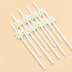 Decorative white paper drinking straws with cute daisy flower cutouts for party table settings.