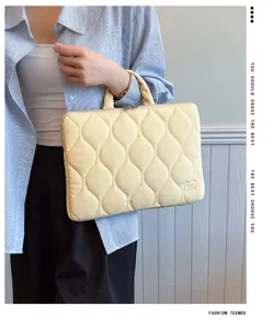 Detailed shot of quilted yellow laptop sleeve with handle, portable and stylish design.