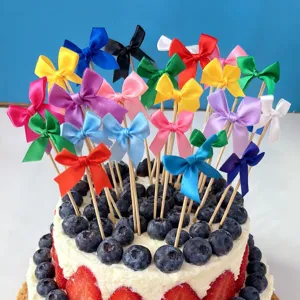 Colorful swallowtail ribbon bow cake toppers with wooden sticks for baking party dessert decors.