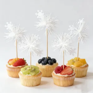 White snowflake cake toppers with fluffy tinsel fringe for Christmas party and dessert decoration.