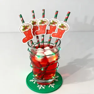 Christmas decorative paper straws with holiday stocking cutouts for festive party drink setup.