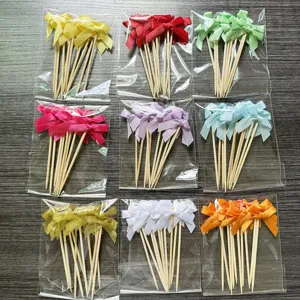 Colorful ribbon bow cupcake picks set, decorative baking toothpick details for party dessert.