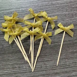 Gold glitter ribbon bow cake toppers, perfect for birthday party baking and dessert decorations.