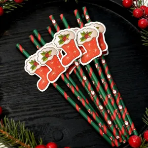 Christmas paper straws detail view with decorative stocking cutouts and festive red green stripes.