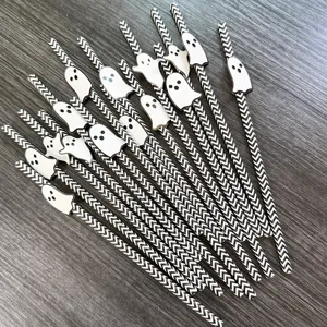 Halloween black and white paper straws with cute ghost toppers for party dessert table decor.