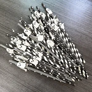 Halloween paper straws detail shot featuring black and white ghost decorations and star patterns.