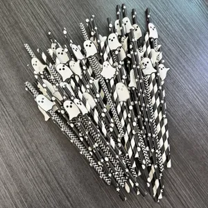 Detailed view of black and white Halloween paper straws with cute ghost decor for parties.