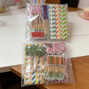 Hawaiian party decoration set including paper straws, flamingo and tropical fruit cake picks.