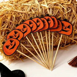 Halloween pumpkin cake toppers detail view, wooden picks for baking and dessert decoration.
